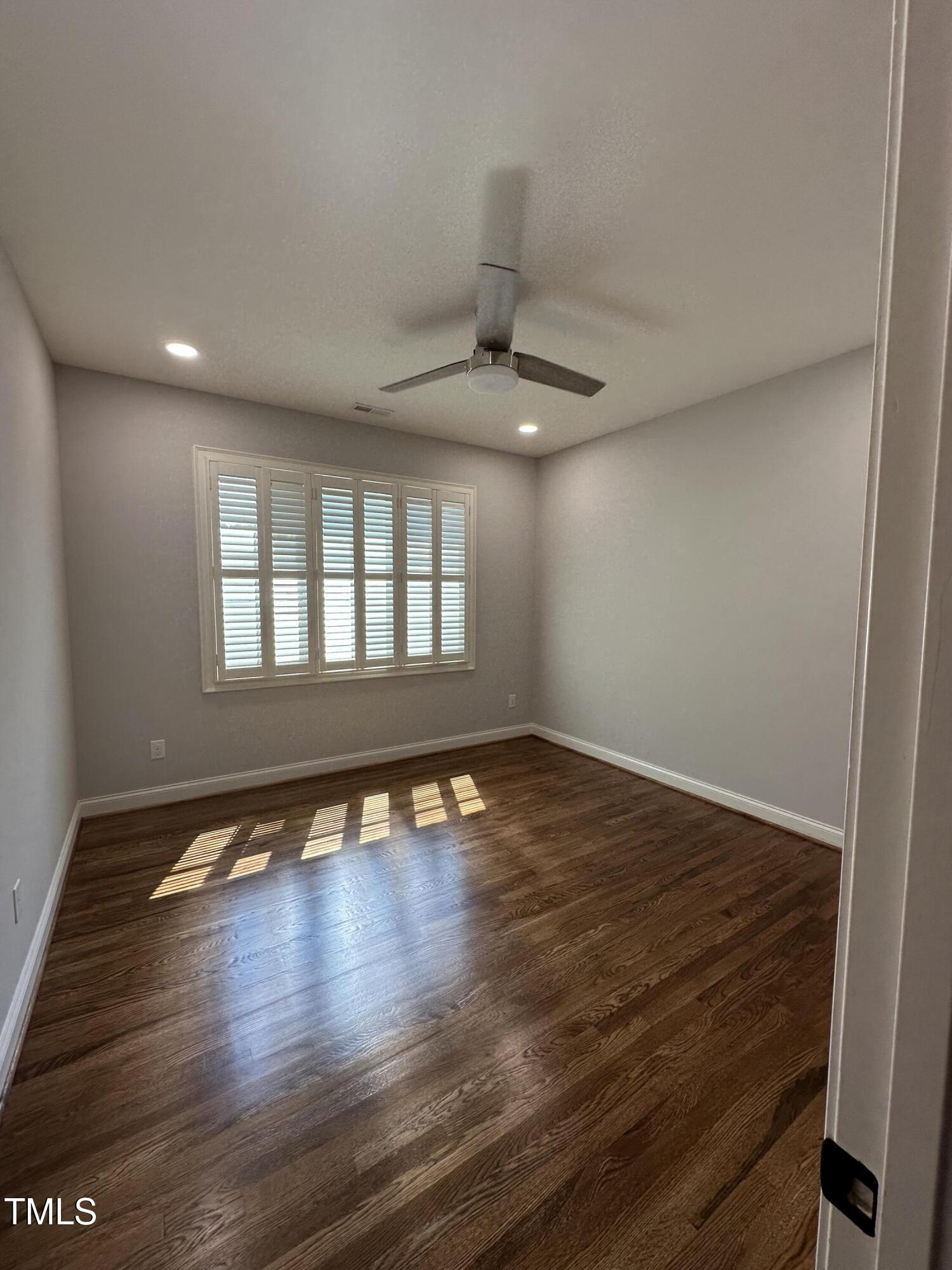 129 Cofield Circle Durham, NC 27707 - Photo 27 of 37 a view of an empty room with wooden floor and a window