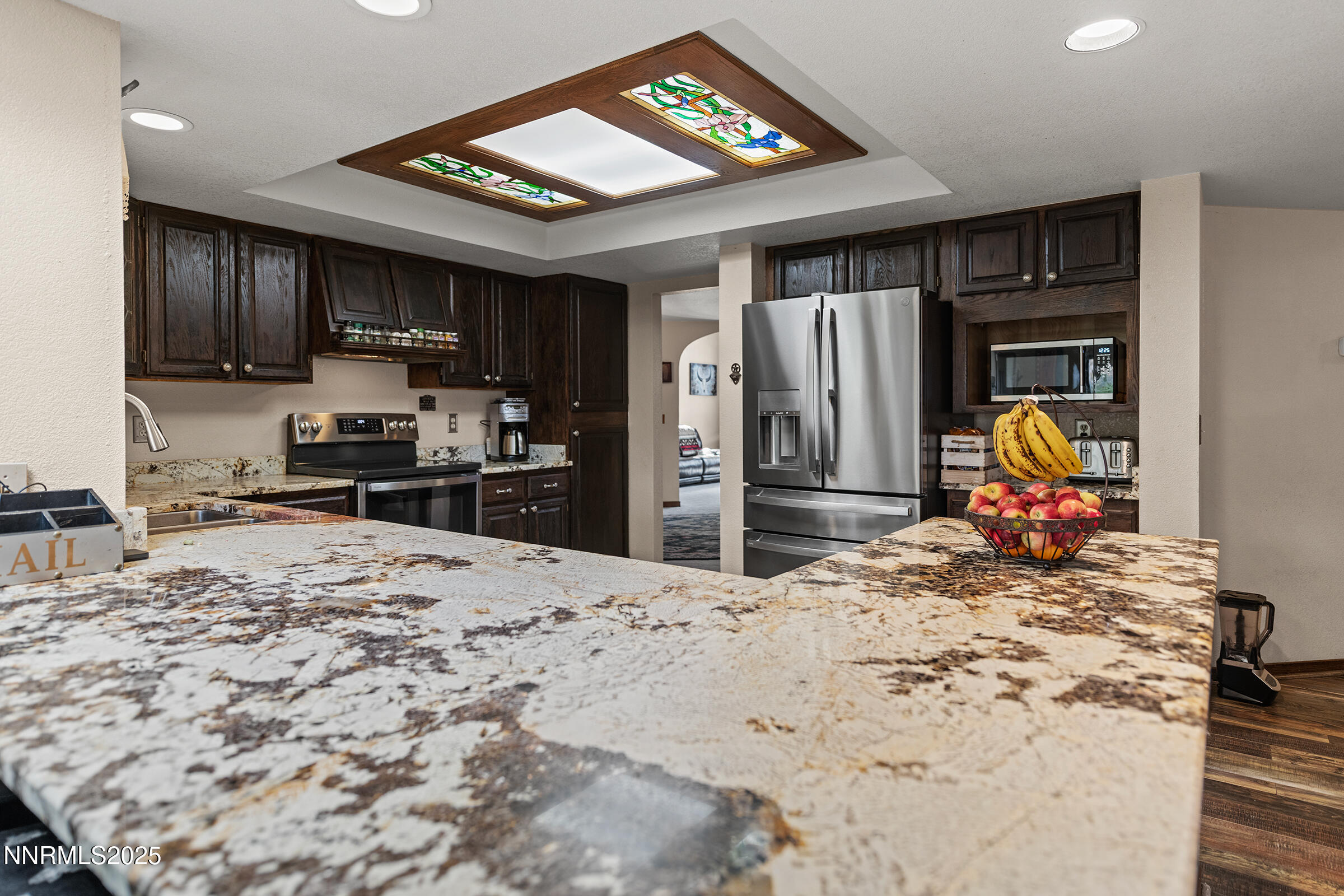 2780 Mario Road Reno, NV 89523 - Photo 12 of 41 a kitchen with stainless steel appliances kitchen island granite countertop a refrigerator and a stove top oven