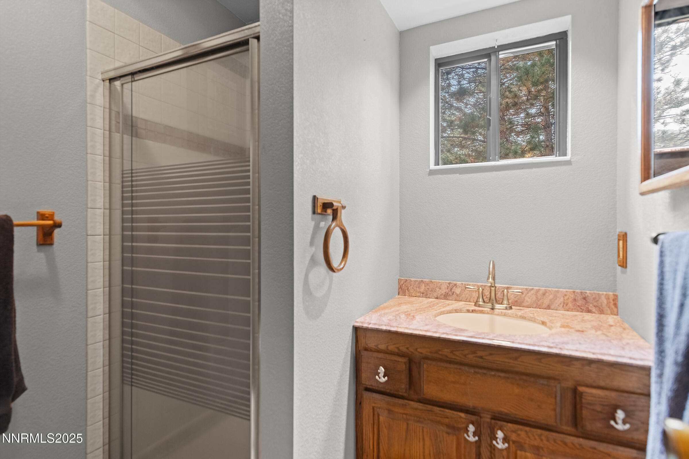 2780 Mario Road Reno, NV 89523 - Photo 17 of 41 a bathroom with a granite countertop sink a shower and a mirror