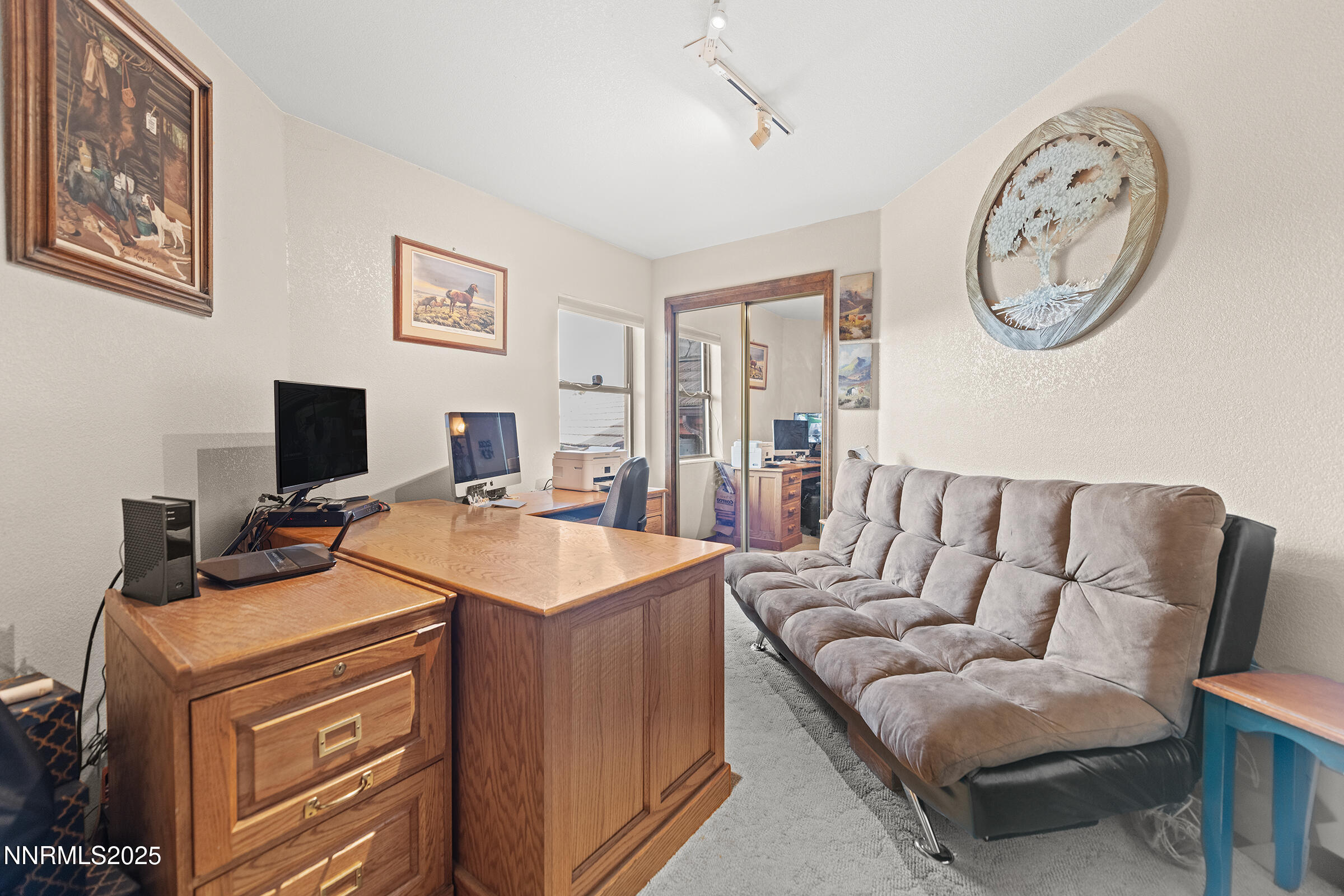 2780 Mario Road Reno, NV 89523 - Photo 18 of 41 a living room with furniture a clock and a flat screen tv