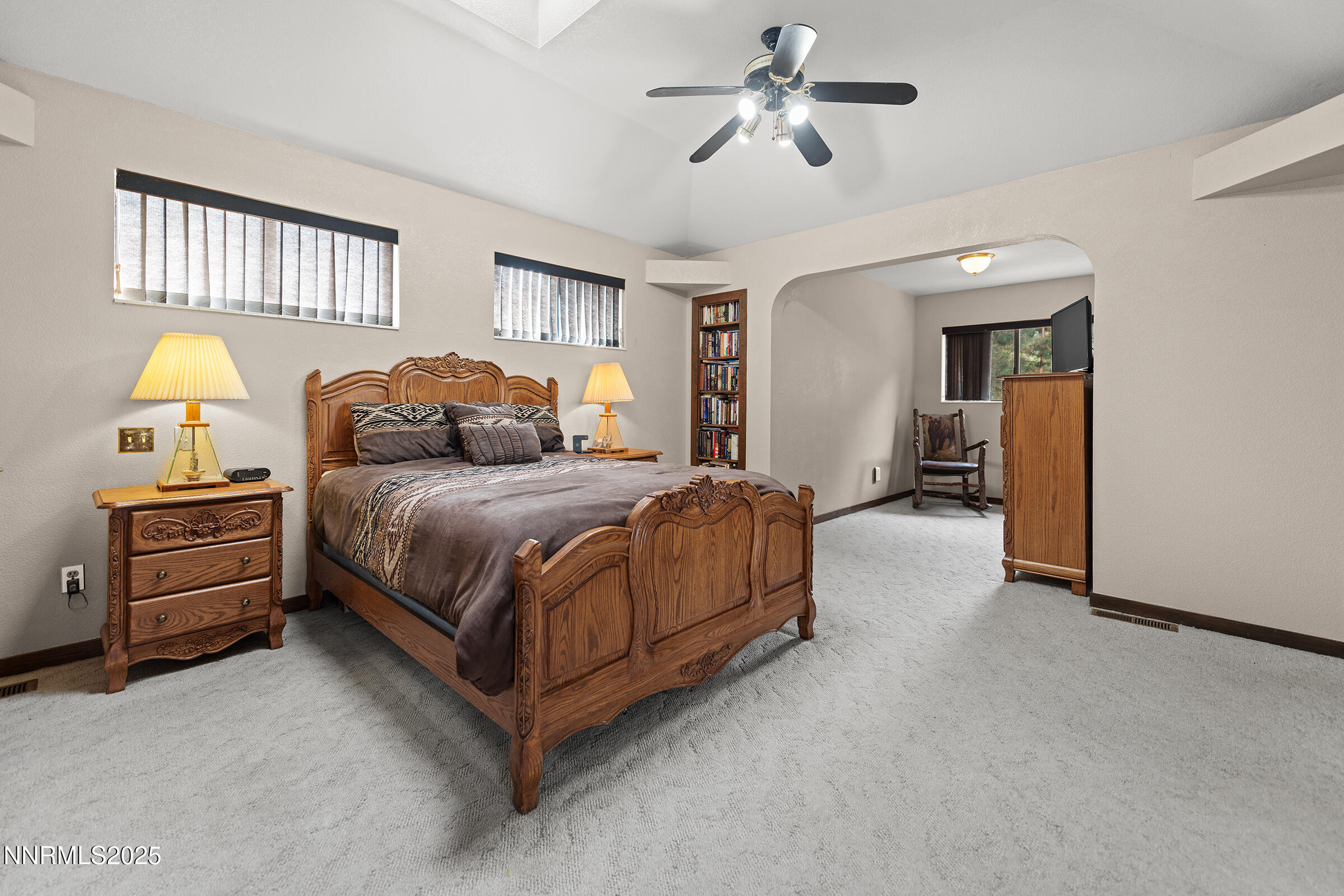 2780 Mario Road Reno, NV 89523 - Photo 21 of 41 a bedroom with a bed and a chandelier