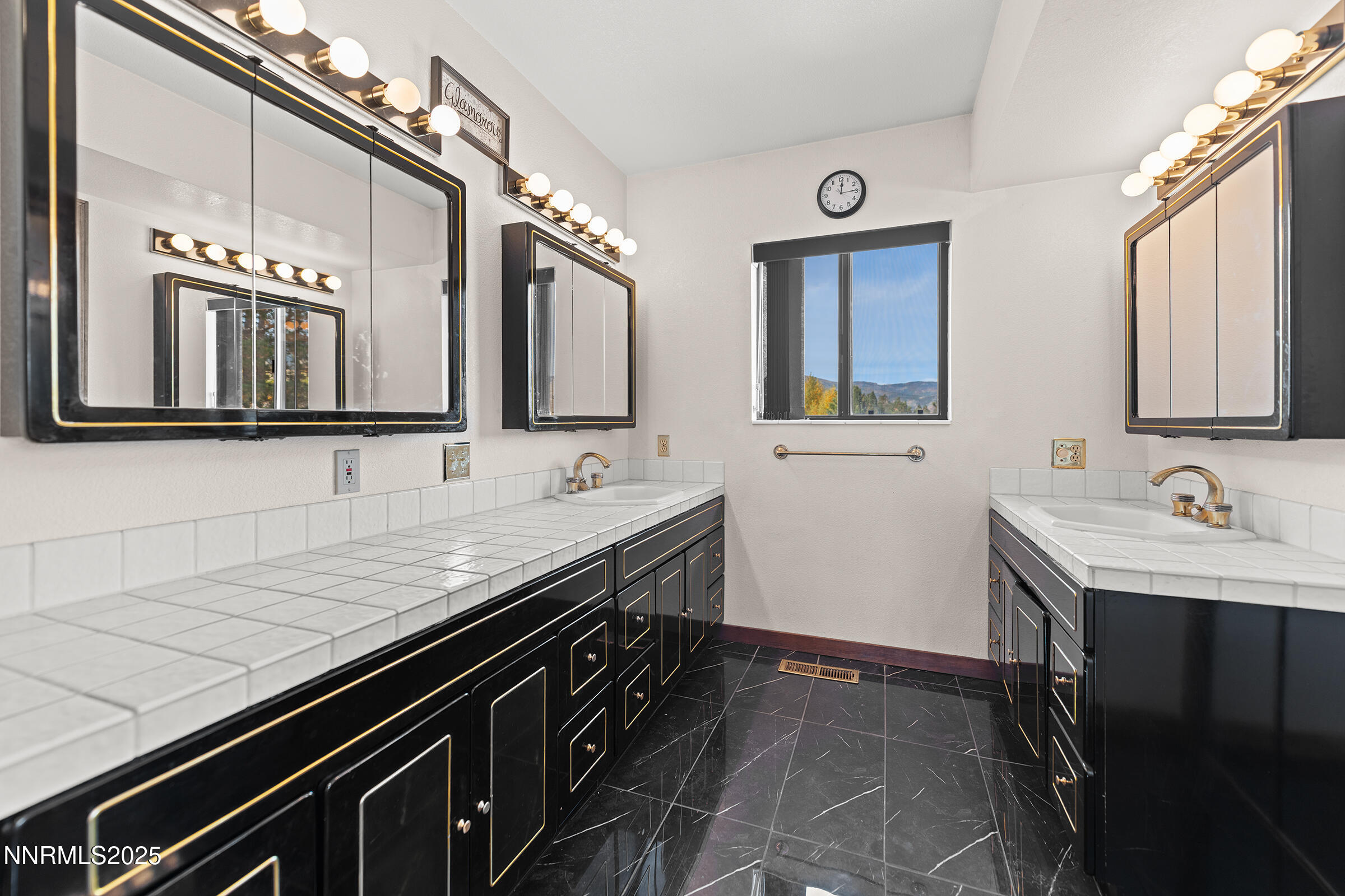 2780 Mario Road Reno, NV 89523 - Photo 24 of 41 a bathroom with a granite countertop sink a mirror and cabinets