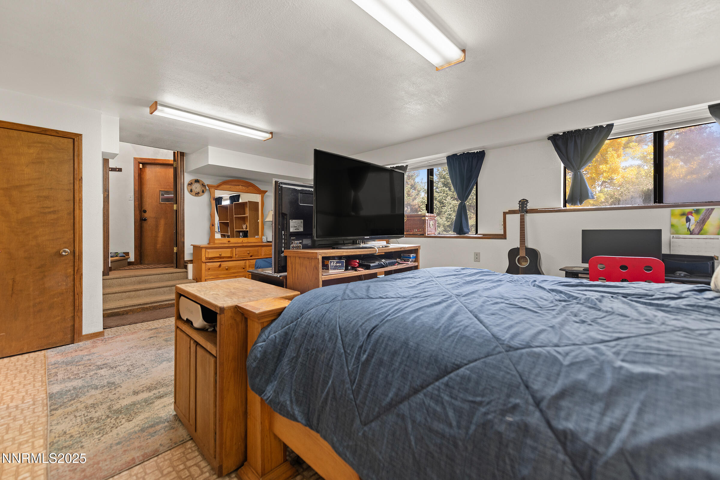 2780 Mario Road Reno, NV 89523 - Photo 30 of 41 a bedroom with a bed and a flat screen tv