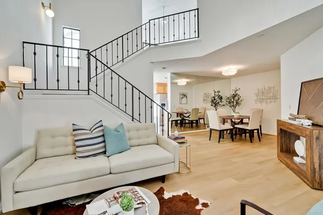 a living room with furniture and a dining table