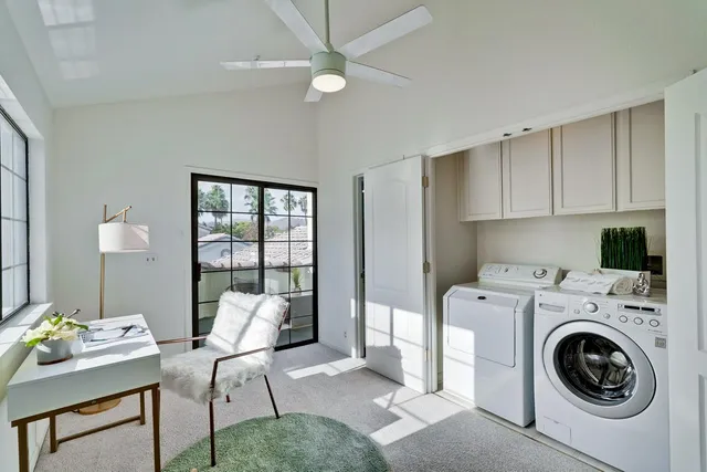 a workspace with furniture and a chandelier fan