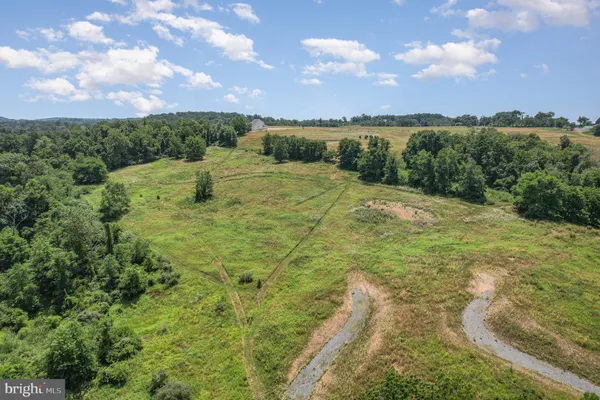 a view of a big yard with lots of green space