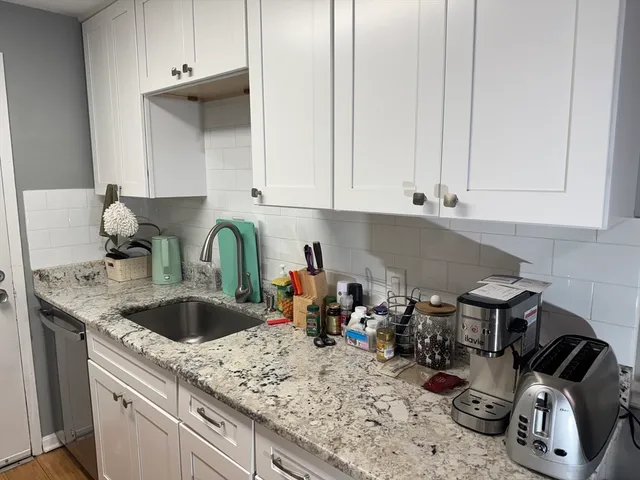 a kitchen with sink and cabinets