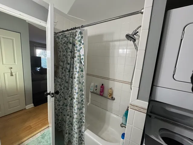 a bathroom with a bathtub and a shower