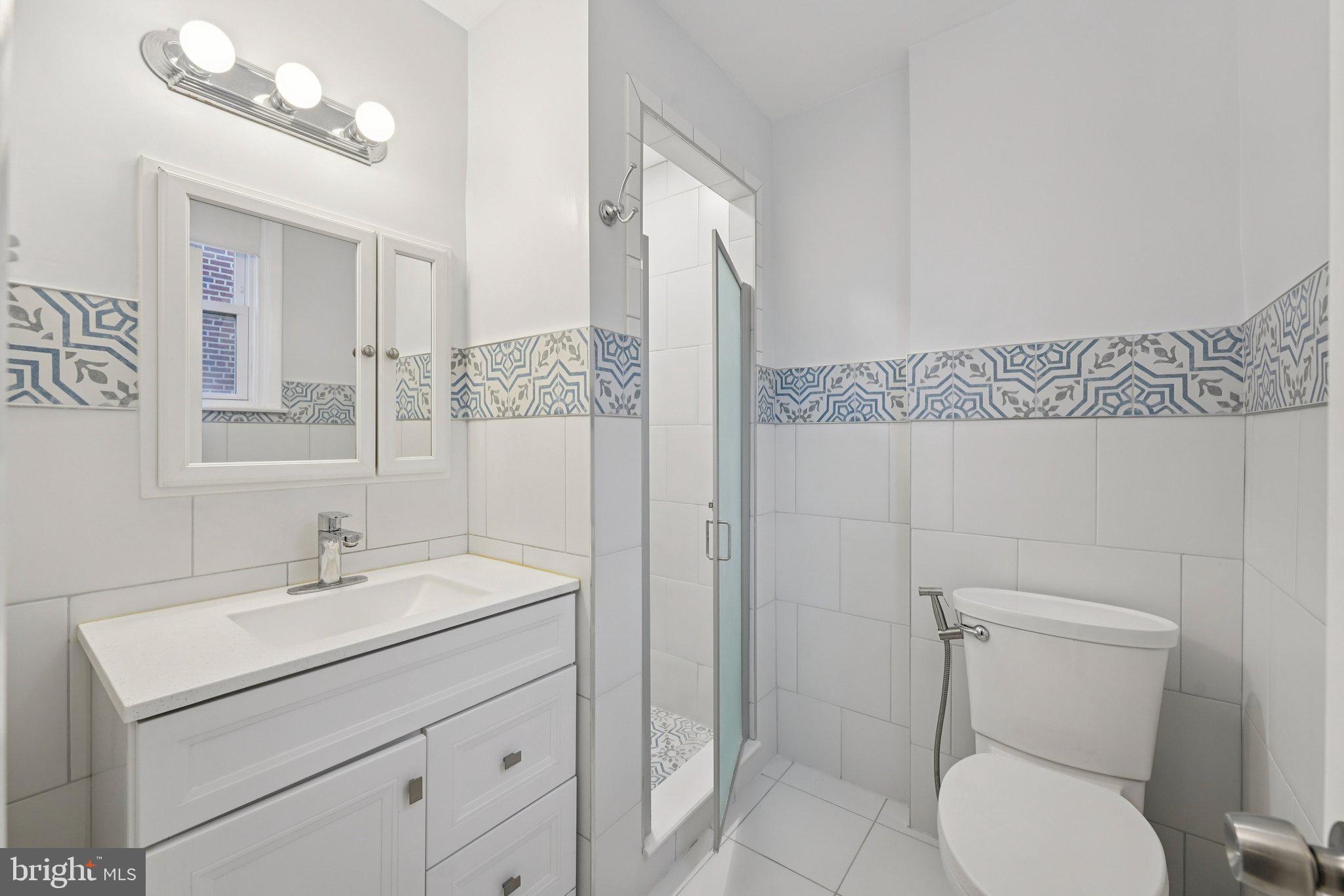 2311 Afton Street Philadelphia, PA 19152 - Photo 13 of 28 a bathroom with a toilet sink and mirror