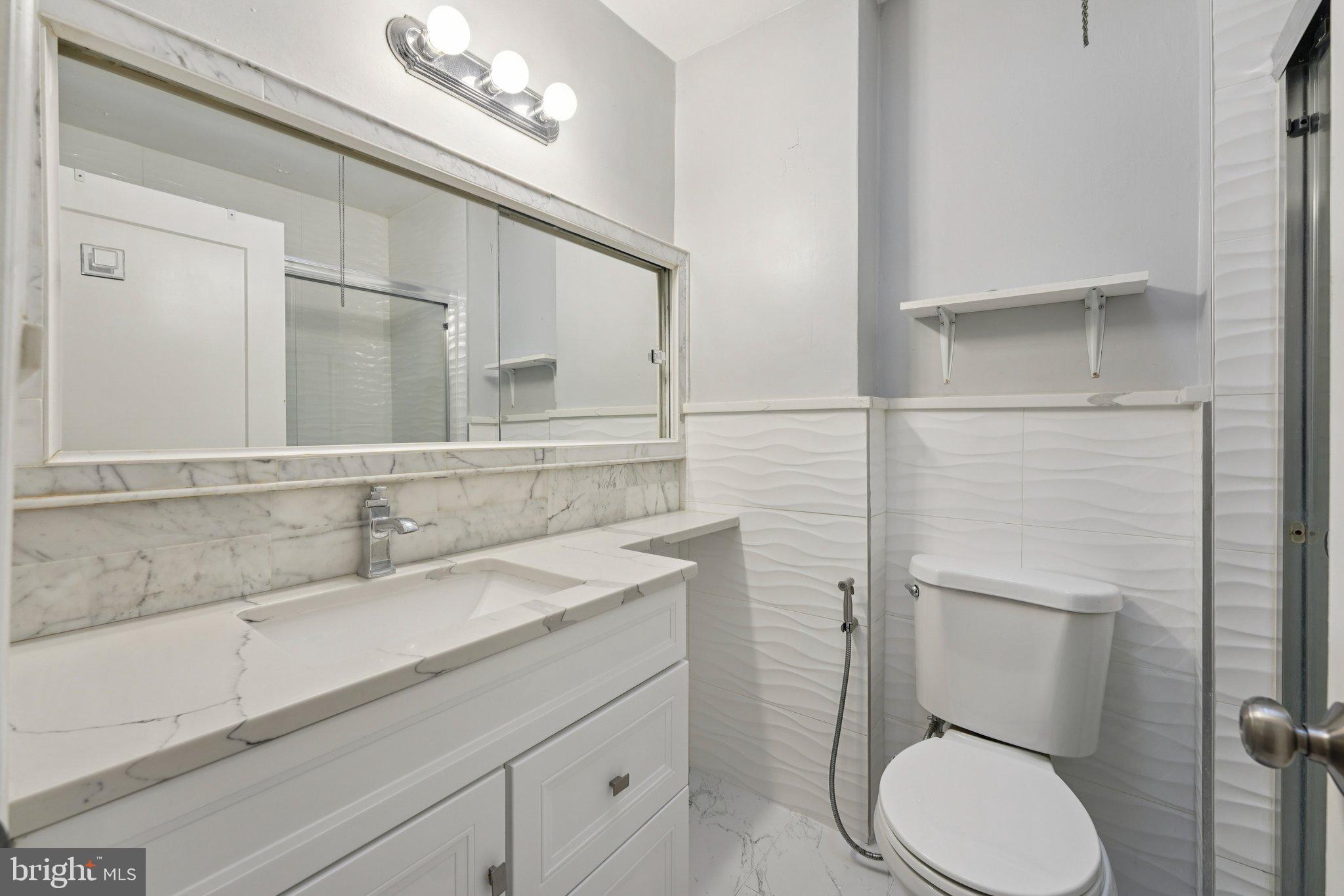 2311 Afton Street Philadelphia, PA 19152 - Photo 18 of 28 a bathroom with a toilet sink and mirror