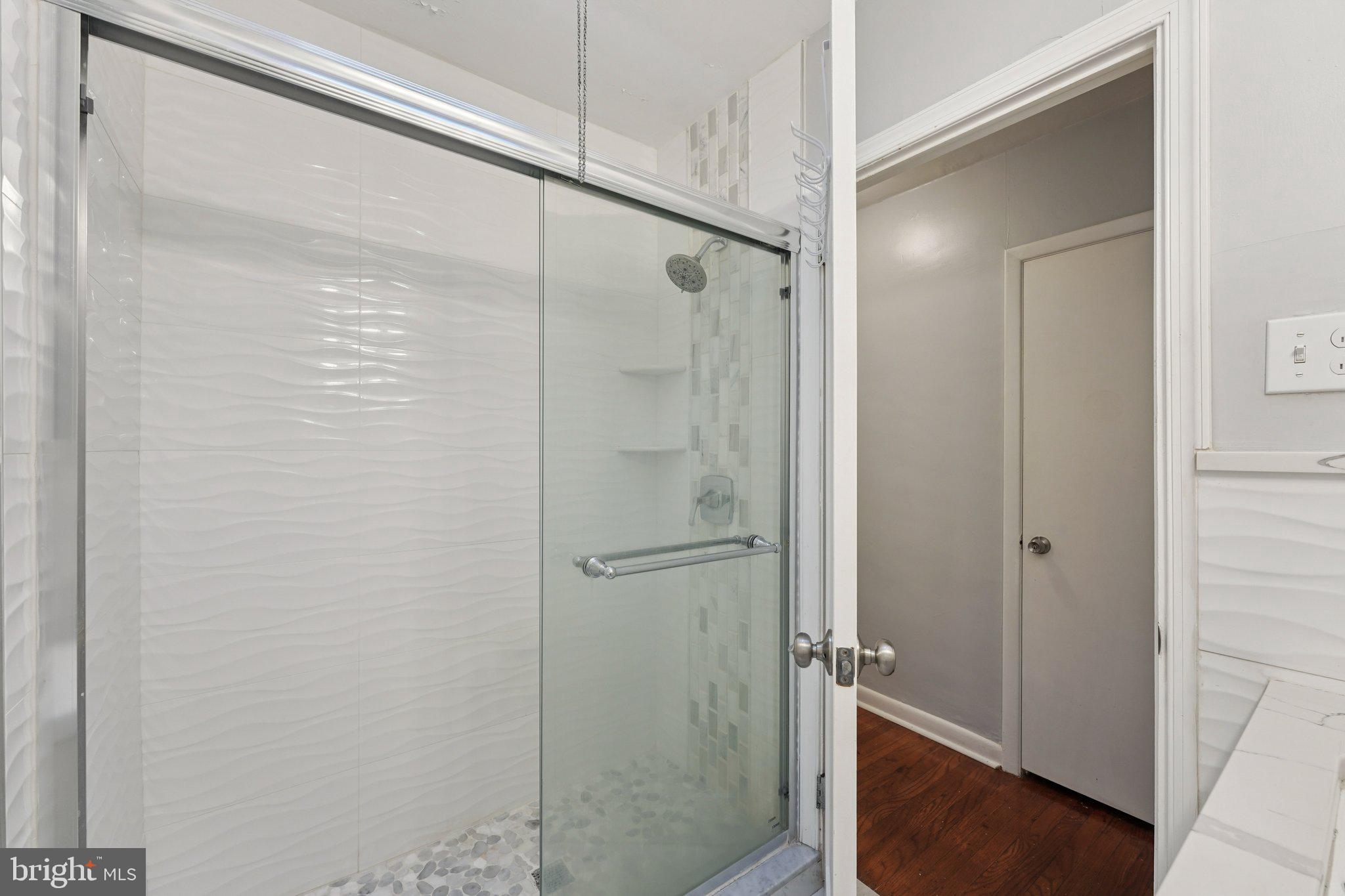 2311 Afton Street Philadelphia, PA 19152 - Photo 19 of 28 a bathroom with a glass shower door