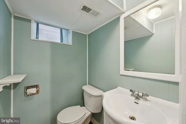 a view of a room with wooden floor and electronic appliances