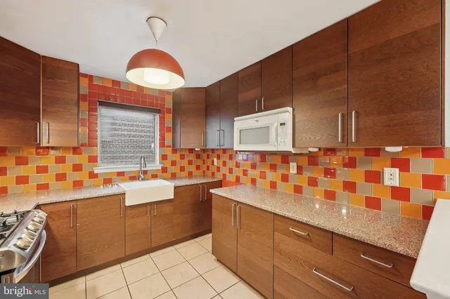 a bathroom with a sink a large mirror and a bathtub