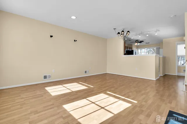 a view of a room with wooden floor
