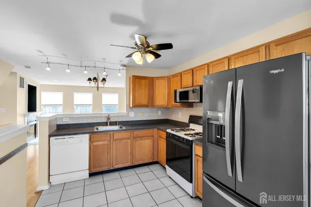 a kitchen with stainless steel appliances a refrigerator sink and stove