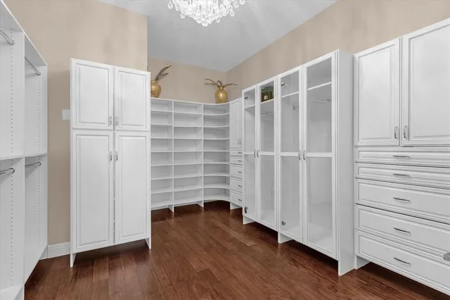 a view of walk in closet with empty racks