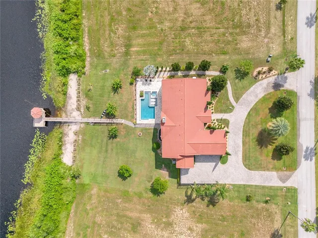 an aerial view of residential house with outdoor space and swimming pool