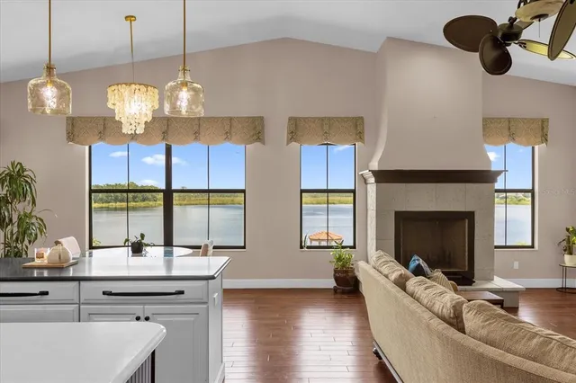 a living room with fireplace furniture and a chandelier