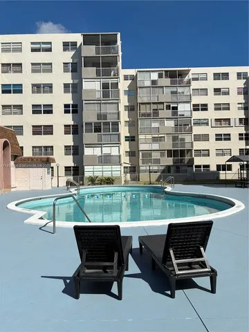 a view of a patio with a table and chairs