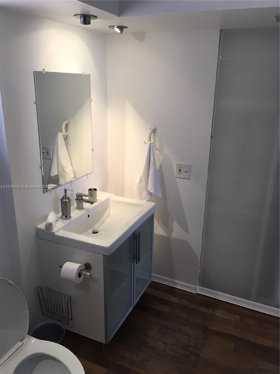 16400 Northeast 17th Avenue, Unit 3042 North Miami Beach, FL 33162 - Photo 7 of 17 a bathroom with a sink vanity granite toilet and a mirror