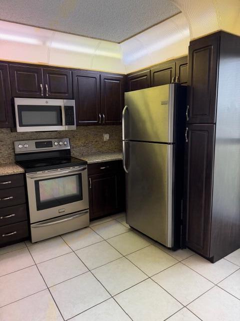 8294 Boca Rio Drive Boca Raton, FL 33433 - Photo 3 of 18 a kitchen with granite countertop a refrigerator and a stove