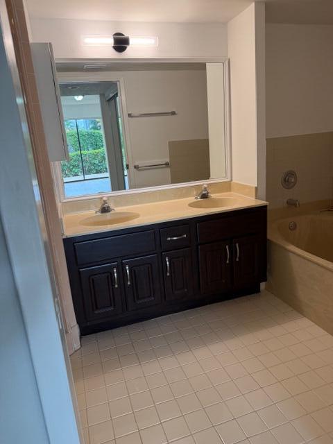 8294 Boca Rio Drive Boca Raton, FL 33433 - Photo 8 of 18 a bathroom with a tub sink and mirror