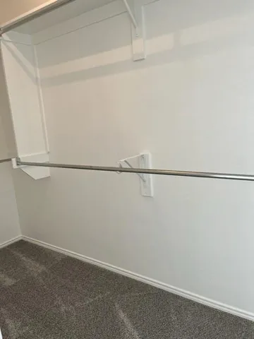 a view of backyard with wooden fence