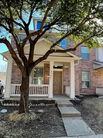 a view of a house with a tree
