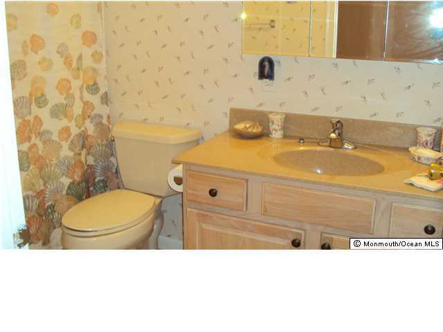 3A Spring Street, Unit B Whiting, NJ 08759 - Photo 11 of 17 a bathroom with a sink a toilet and a mirror