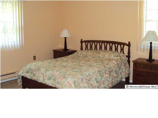 3A Spring Street, Unit B Whiting, NJ 08759 - Photo 12 of 17 a bedroom with a bed and a lamp with window