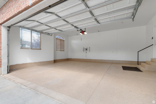 1501 West Elk Circle Mapleton, UT 84664 - Photo 10 of 39 Spacious garage featuring a durable epoxy floor coating, white painted walls, and an arched window