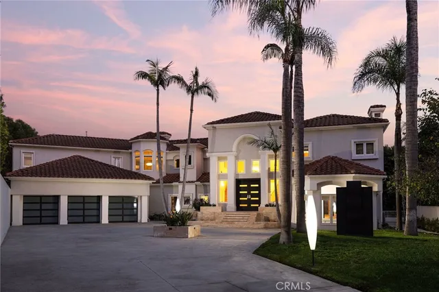 a front view of a building with palm trees