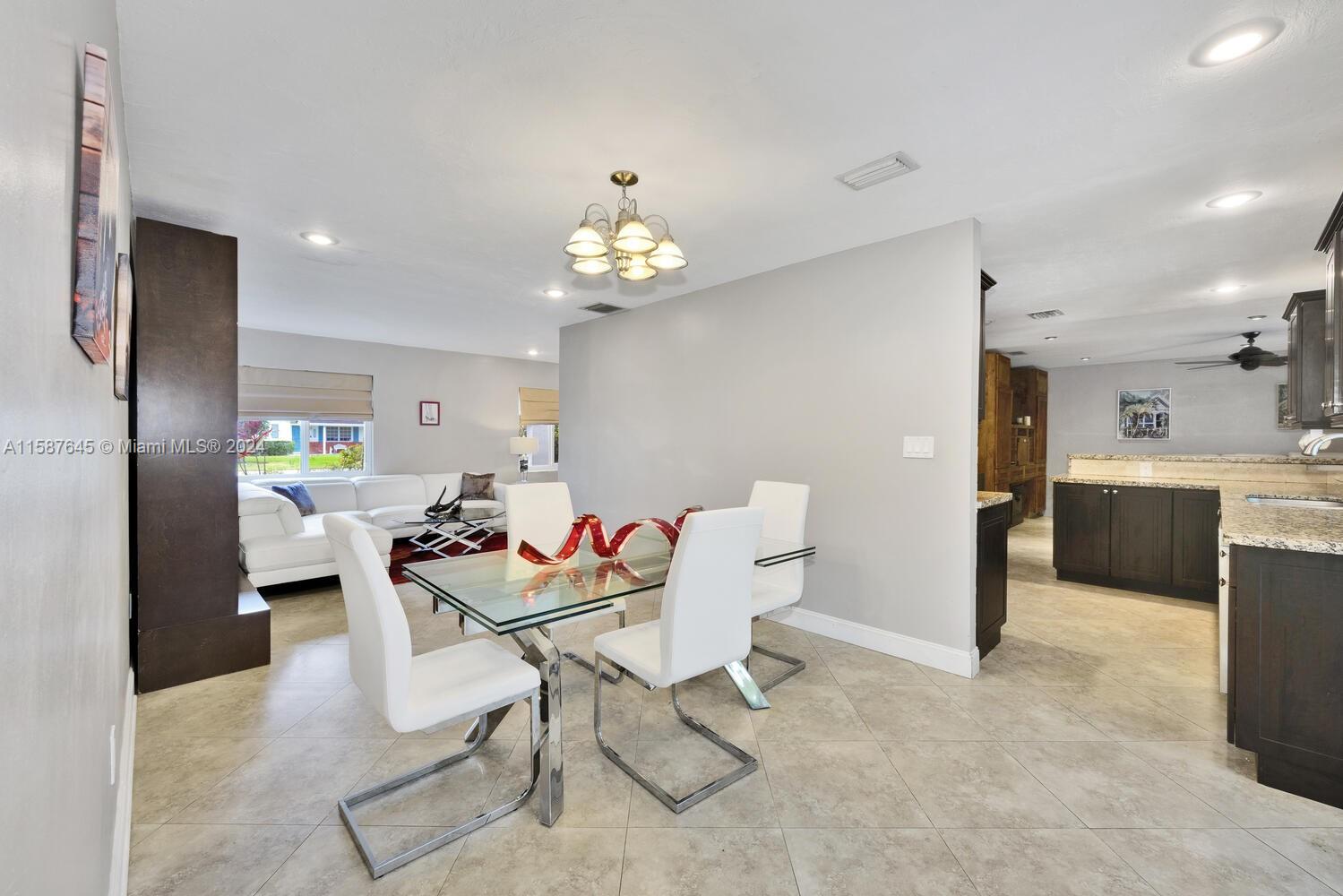 18565 Southwest 295th Terrace Homestead, FL 33030 - Photo 15 of 42 a living room with furniture a dining table and kitchen view