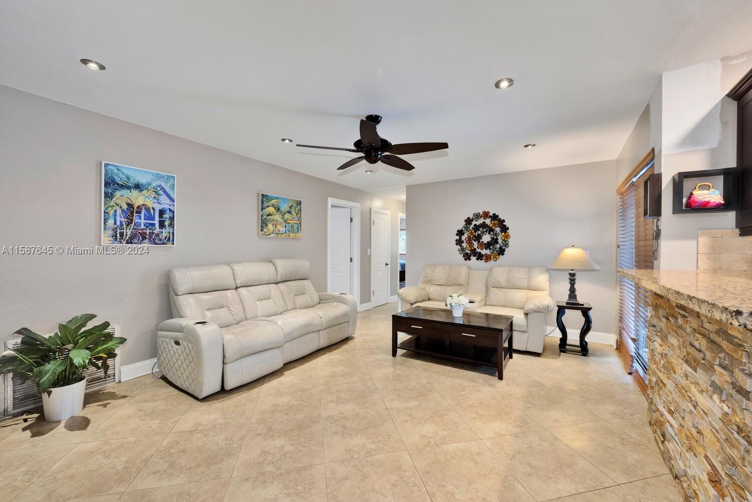 18565 Southwest 295th Terrace Homestead, FL 33030 - Photo 17 of 42 a living room with furniture and a chandelier