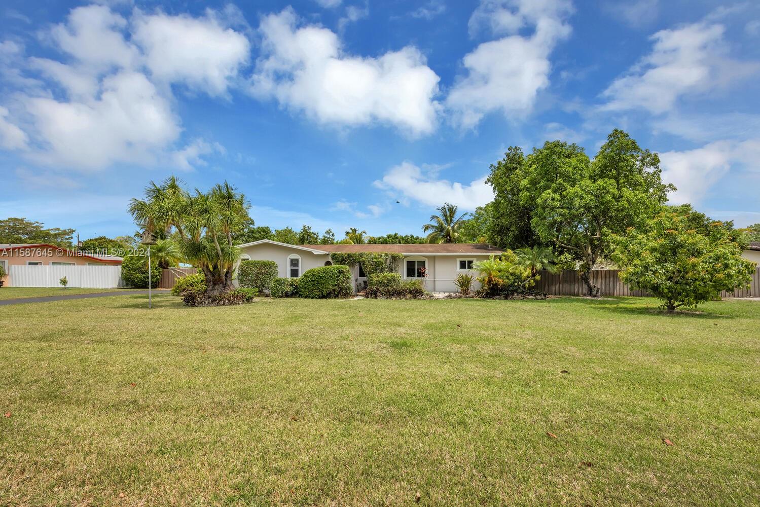 18565 Southwest 295th Terrace Homestead, FL 33030 - Photo 2 of 42 a front view of a house with a big yard