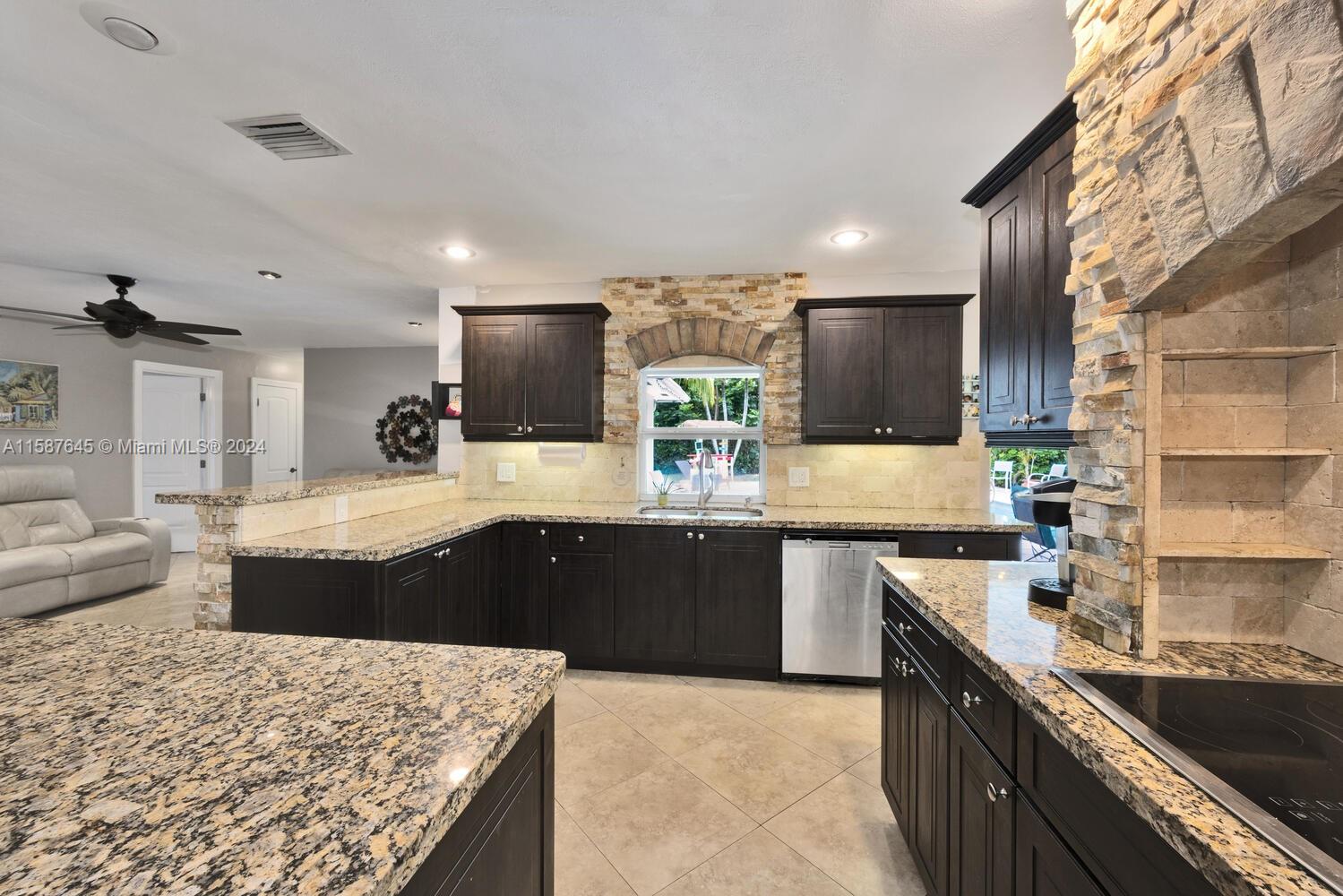 18565 Southwest 295th Terrace Homestead, FL 33030 - Photo 23 of 42 a large kitchen with granite countertop lots of counter space and sink