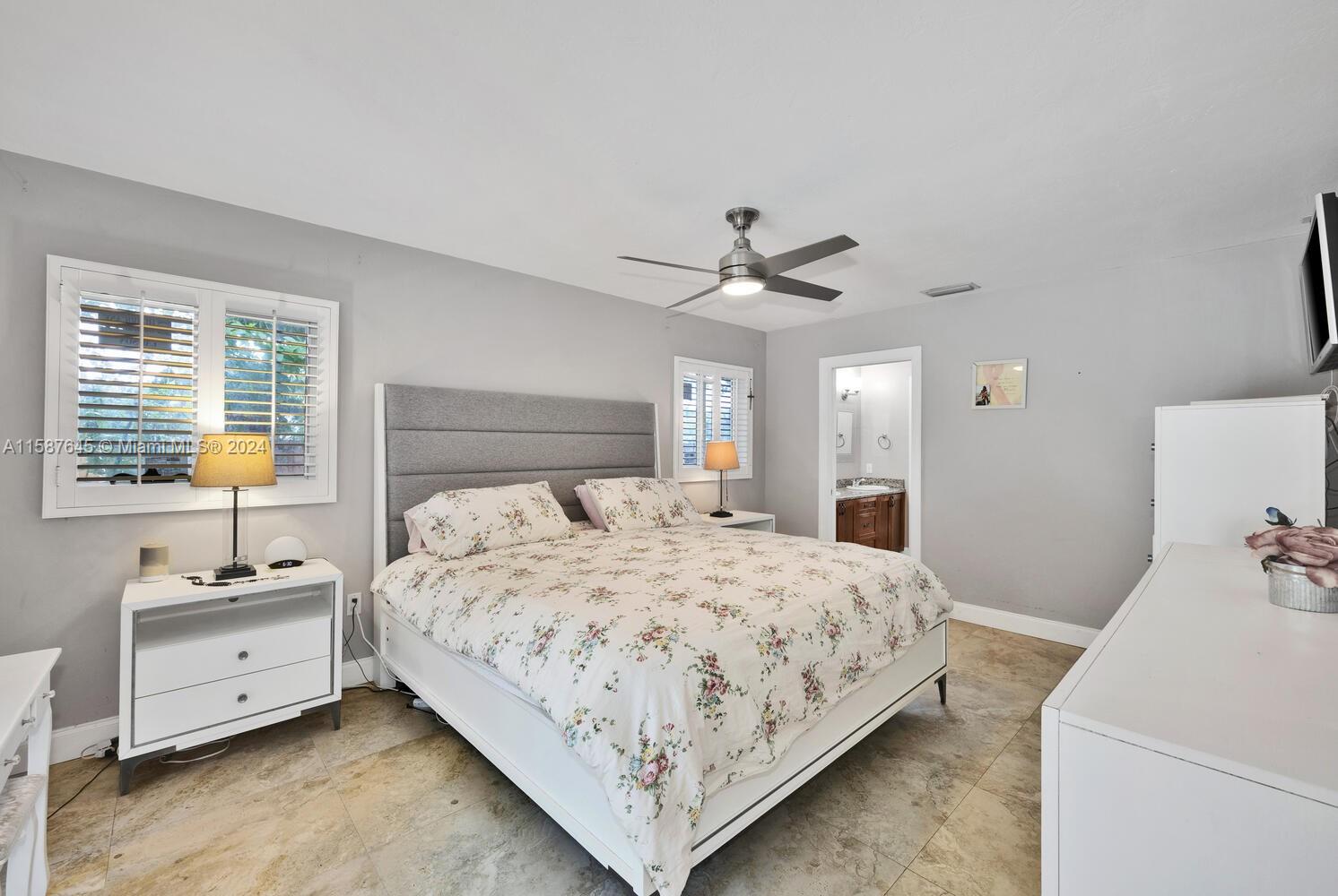 18565 Southwest 295th Terrace Homestead, FL 33030 - Photo 25 of 42 a bedroom with a bed and a chandelier