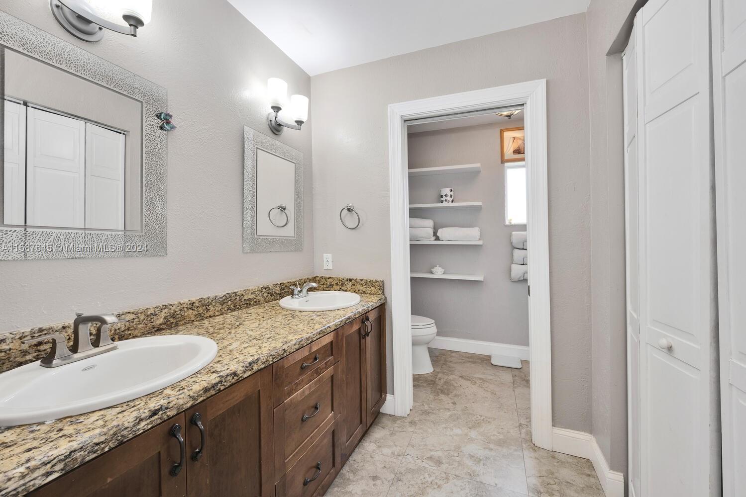 18565 Southwest 295th Terrace Homestead, FL 33030 - Photo 27 of 42 a bathroom with a granite countertop sink and a mirror