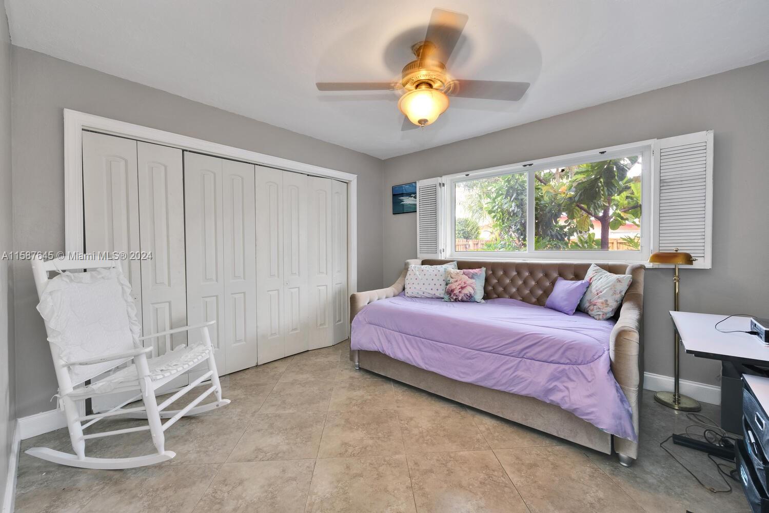 18565 Southwest 295th Terrace Homestead, FL 33030 - Photo 30 of 42 a bedroom with a bed and a chandelier