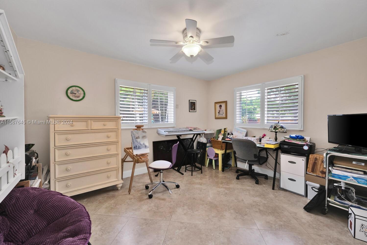 18565 Southwest 295th Terrace Homestead, FL 33030 - Photo 31 of 42 a living room with furniture and a flat screen tv