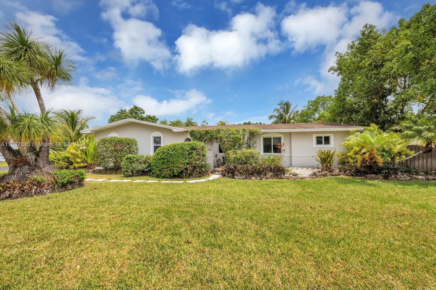 18565 Southwest 295th Terrace Homestead, FL 33030 - Photo 6 of 42 a front view of a house with garden