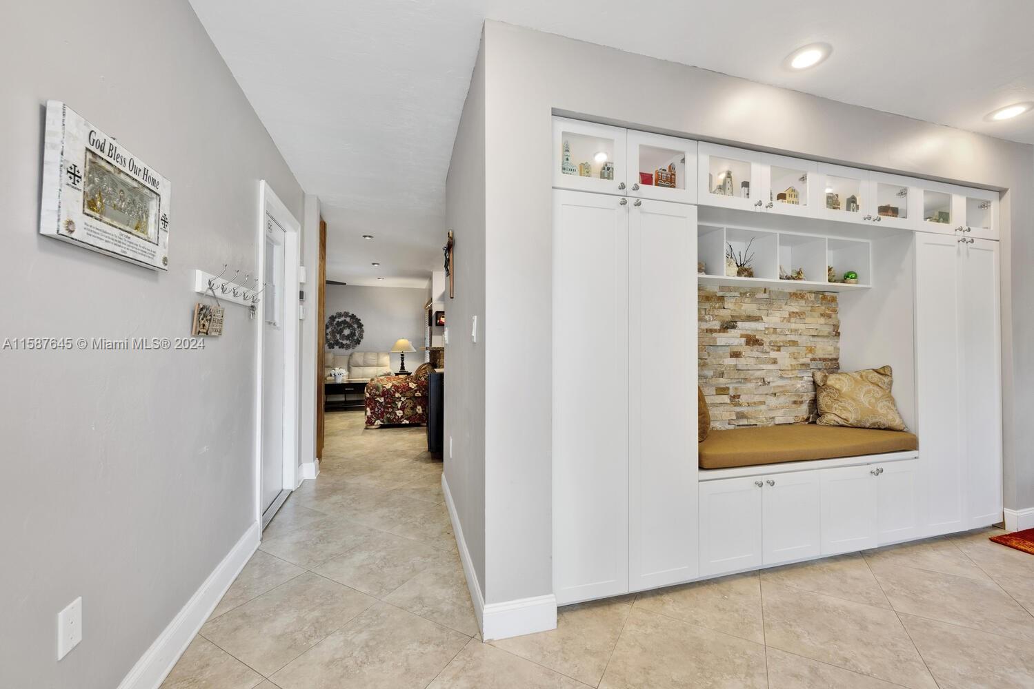 18565 Southwest 295th Terrace Homestead, FL 33030 - Photo 8 of 42 a view of a hallway with shelves and workspace