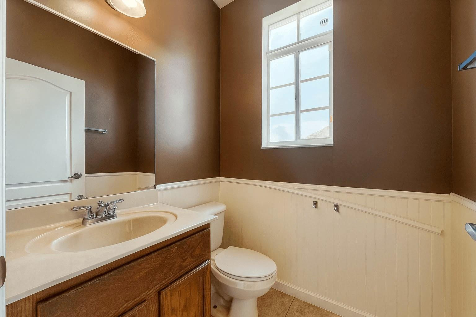14218 Southwest 272nd Street, Unit 1 Homestead, FL 33032 - Photo 11 of 24 a bathroom with a sink toilet vanity and window