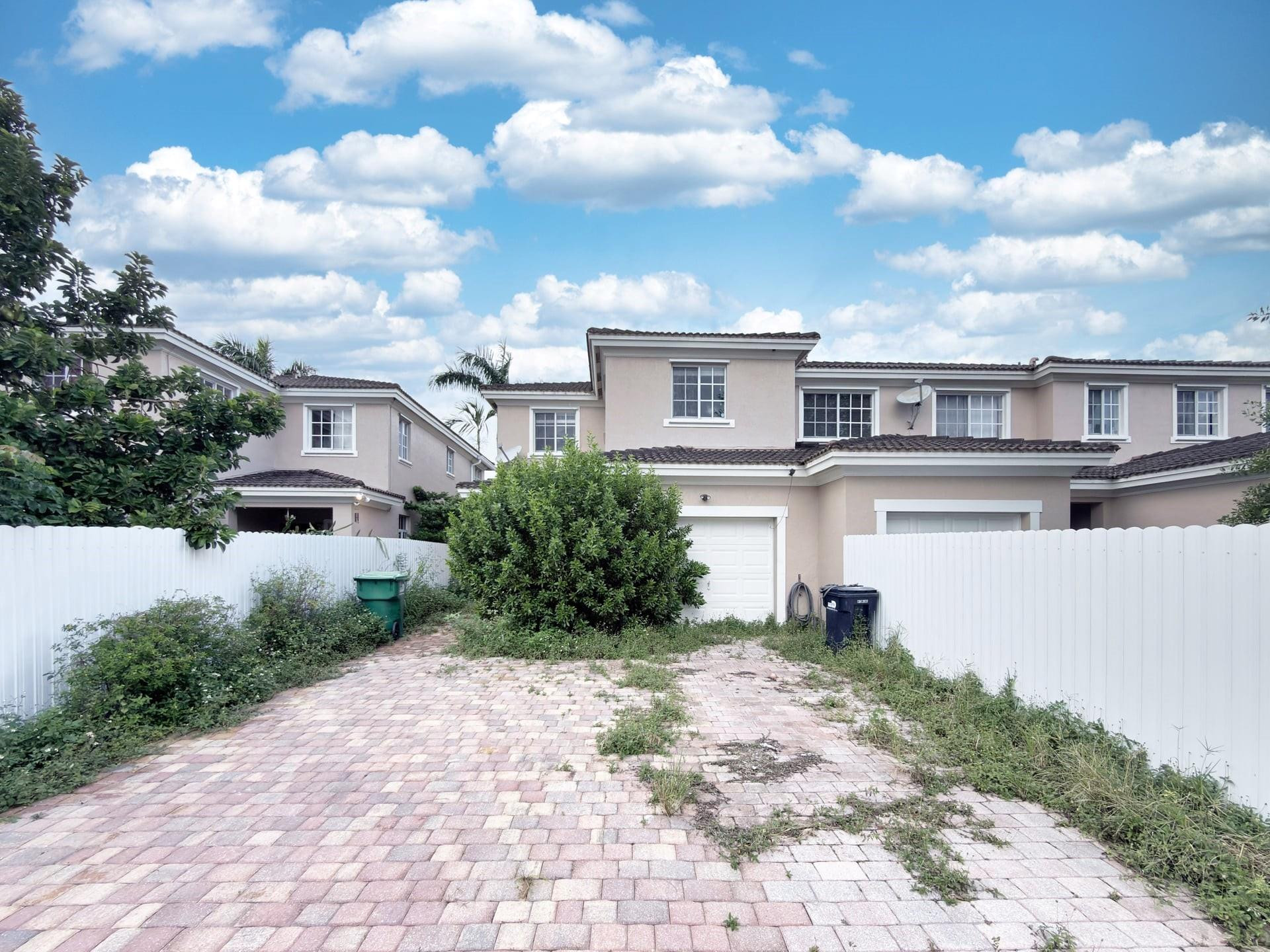 14218 Southwest 272nd Street, Unit 1 Homestead, FL 33032 - Photo 2 of 24 a view of a house with a yard