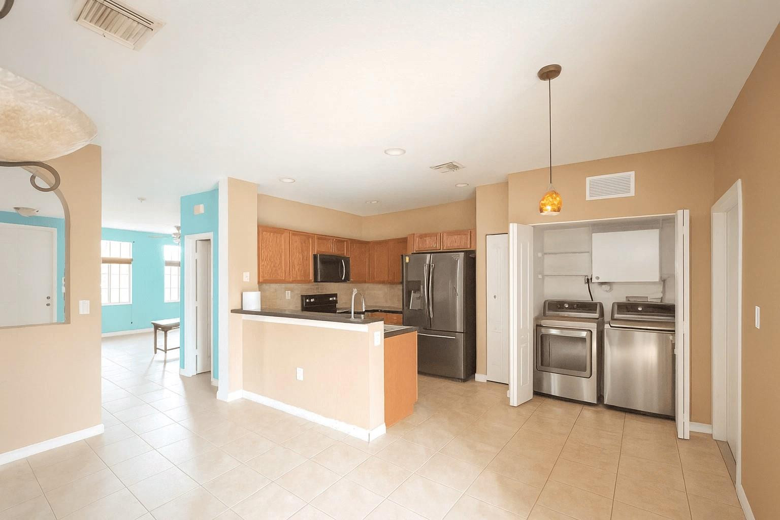 14218 Southwest 272nd Street, Unit 1 Homestead, FL 33032 - Photo 7 of 24 a kitchen with stainless steel appliances a refrigerator sink and stove