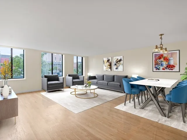 a living room with furniture a rug and a table