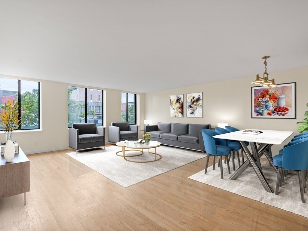 a living room with furniture a rug and a table