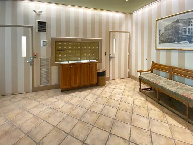 a view of a livingroom with kitchen and furniture