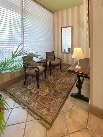 a living room with dining table and a window
