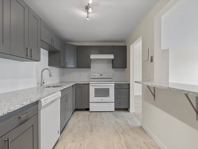 a kitchen with a stove oven and sink